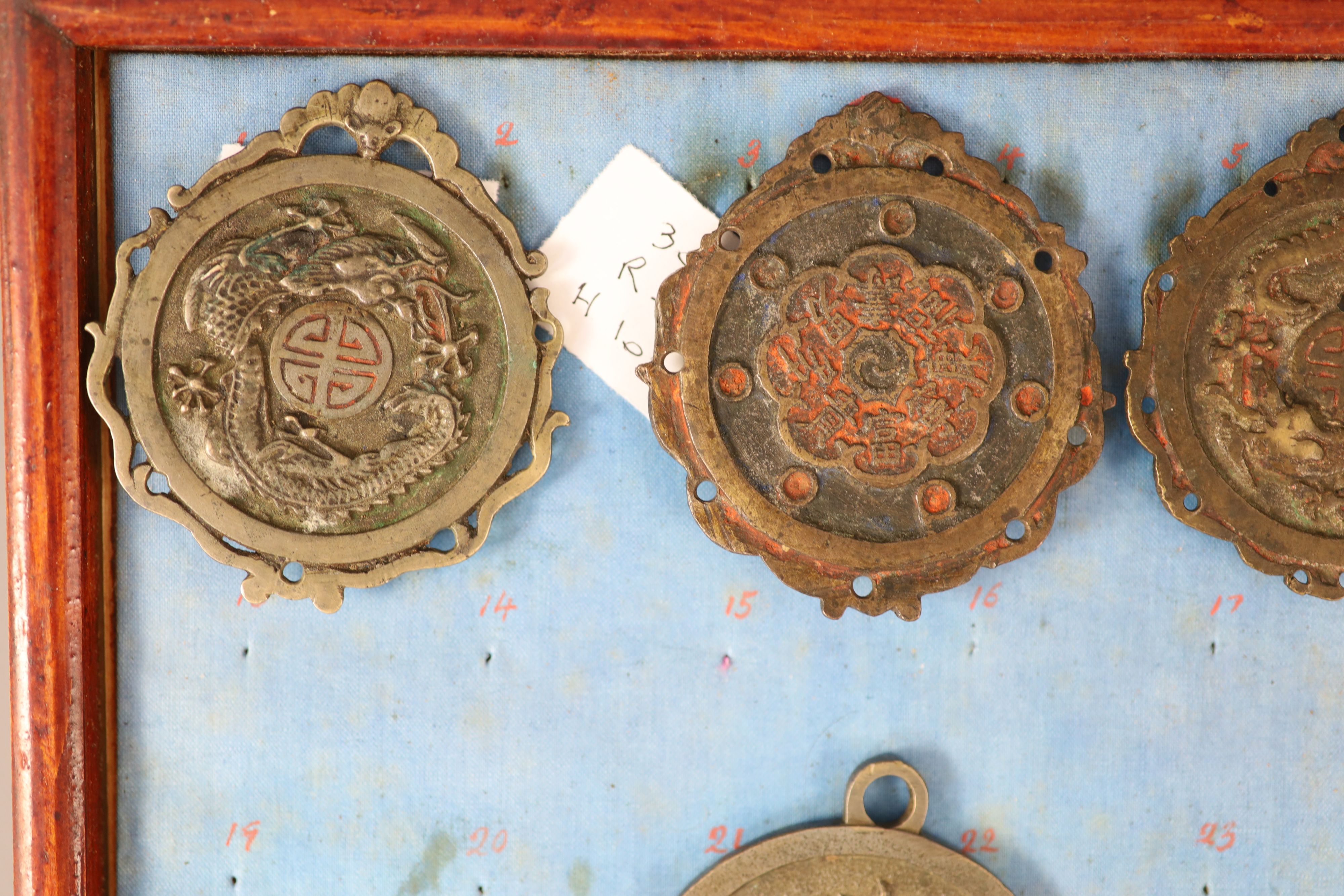 A group of 99 Korean bronze and metal amulets or charms, 19th/20th century